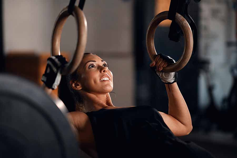 Woman holding gymnastic rings in gym  Gymnastics workout, Gymnastic rings,  Gym