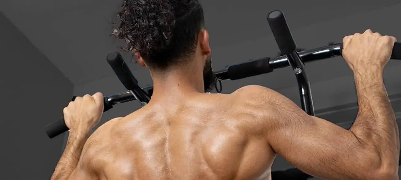 Man doing a wide-grip pull-up on the DMoose doorway pull-up bar, back muscles engaged