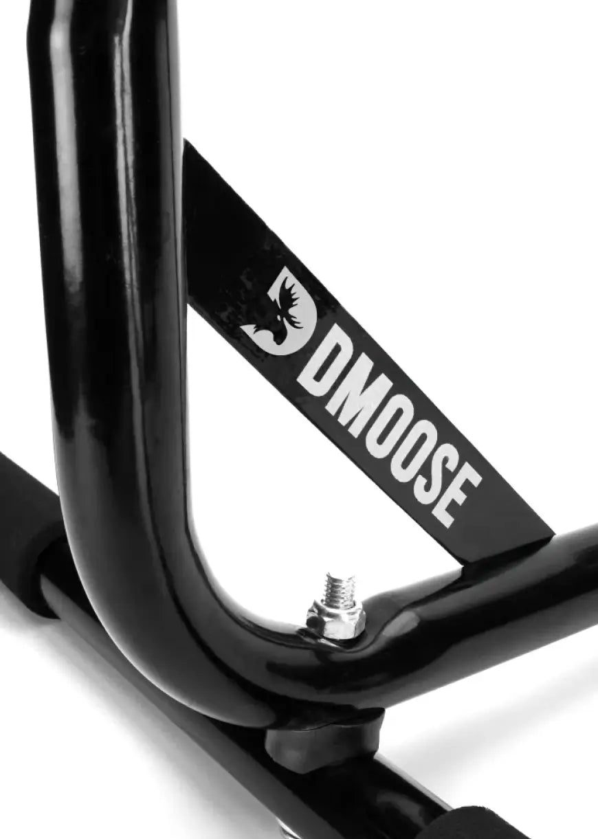 Close-up of the pull-up bar's welded heavy-duty steel frame joint with the DMoose badge and a locking bolt