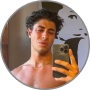 Chris O., a young man with curly hair taking a shirtless mirror selfie
